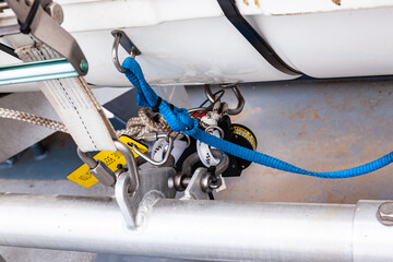 A life raft in a capsule is fixed on the deck of a ship, close-up. Mechanism for securing life...