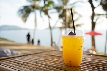Orange juice on  table seaside during sunset sky.