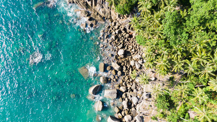 waves breaking to rock cliff.