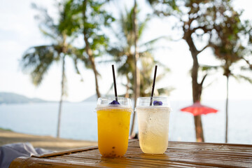 Orange juice on  table seaside during sunset sky.