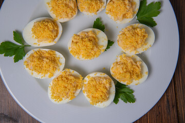Stuffed eggs with crab crumbs, mayonnaise and parsley macro on a plate