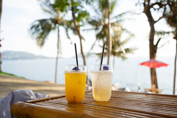 Orange juice on table seaside during sunset sky.