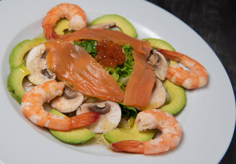 Healthy breakfast with salmon, salad, avocado mushroom, salmon egg, red onion