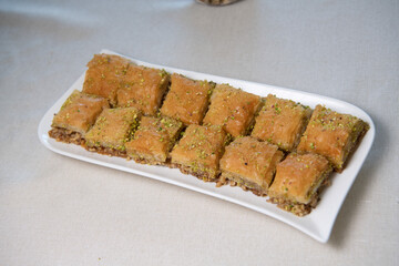 Baklawa on a plate on a table, top view, baklava, feast treat ramadan traditional dessert, High quality photo