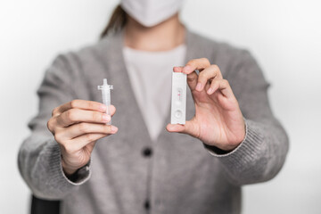 Close up of a person demonstrating tools of coronavirus covid-19 rapid antigen home test
