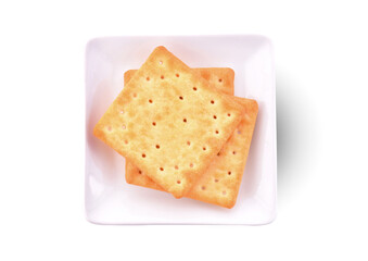 Thin crispy biscuits in a plate isolated on white background. Top view.