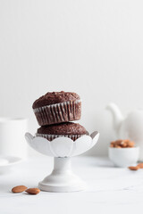 Chocolate muffins in a white cake stand