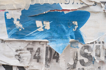 Grungy street poster background. Torn and ripped paper texture. Abstract collage layers of vintage street poster.