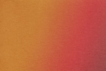 Fototapeta premium Texture of old dark red and orange colors paper background with soft gradient, macro.