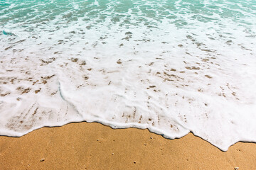 Low angle shot of sea wave foam and turquoise water