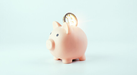 Save currency bitcoin. Pink pig bank with golden bit coin money BTC on white background. Save money investment and business finance.