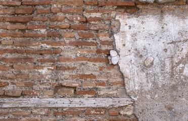 plastered brick wall of ruined building