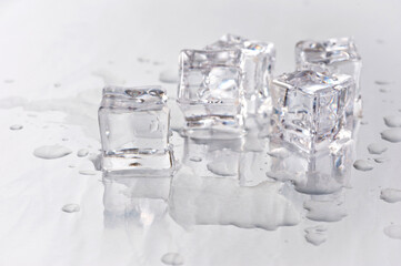 Clear ice cubes for cooling drinks on a light background.
