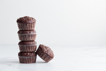 The stack of chocolate muffins on a white background