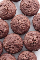 Pile of chocolate muffins on a white background