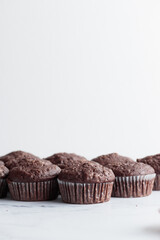 Pile of chocolate muffins on a white background