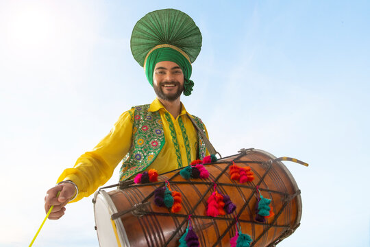 Portrait of Sikh man playing drum during Baisakhi celebration