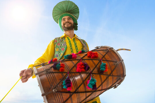 Portrait of Sikh man playing drum during Baisakhi celebration