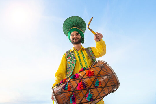 Portrait of Sikh man playing drum during Baisakhi celebration