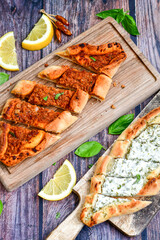  Traditional Turkish cuisine. Baked Pide dish with minced  beef, tomatoes and cheese on  wooden background.  Turkish pizza pide