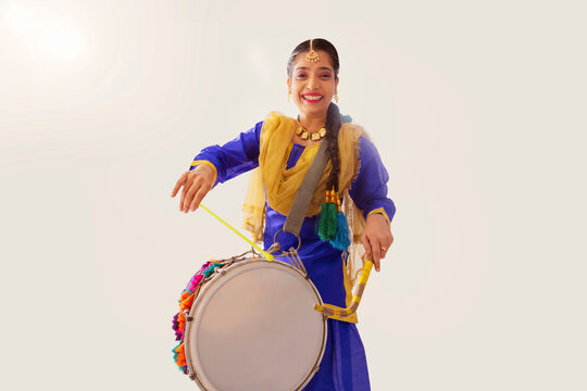 Portrait of Sikh woman playing drum during Baisakhi celebration