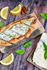  Traditional Turkish cuisine. Baked Pide dish with minced  beef, tomatoes and cheese on  wooden background.  Turkish pizza pide