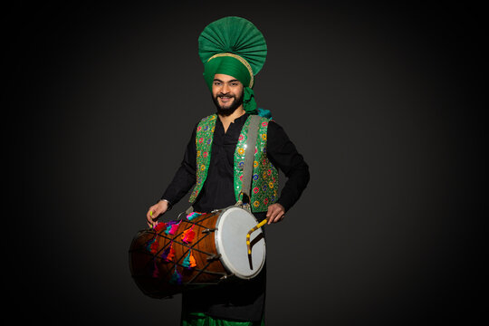 Portrait of Sikh man playing drum during Baisakhi celebration