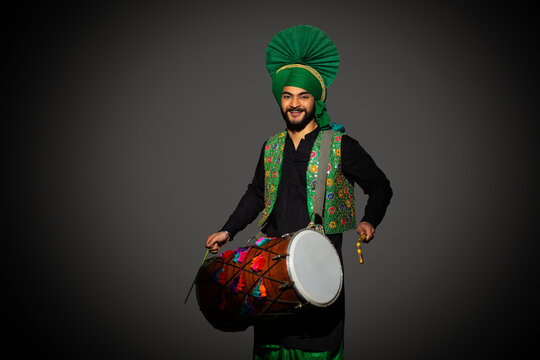 Portrait of Sikh man playing drum during Baisakhi celebration