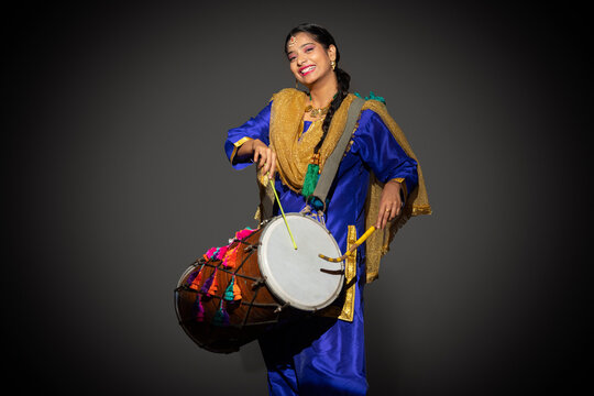 Portrait of Sikh woman playing drum during Baisakhi celebration