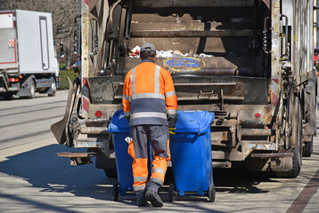 Fototapeta premium Garbage truck on the city street