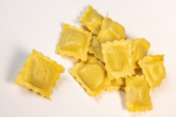Tasty raw ravioli with flour and spinach on white background, process of making italian ravioli, High quality photo