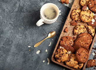 Plate with chocolate cookies and cup of hot coffee. Sweet dessert.