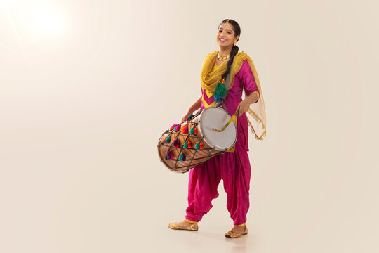 Portrait of Sikh woman playing drum during Baisakhi celebration
