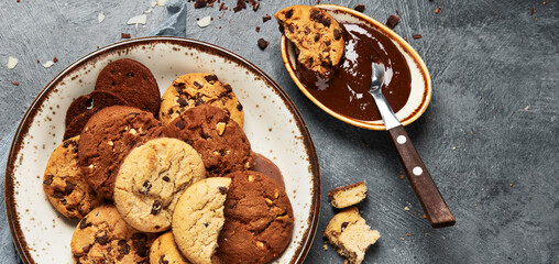 Plate with chocolate cookies and cup of hot coffee. Sweet dessert.