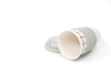 Checkered ceramic cup with rubber lid, shot against a white background.