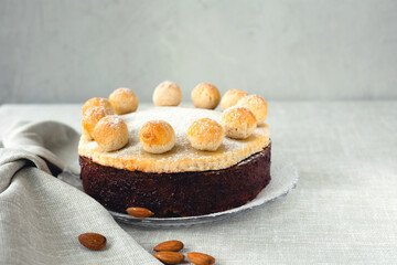 Easter cake simnel for breakfast on a grey background.