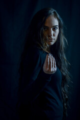 Portrait of a beautiful young Italian woman with very long hair making a typical Italian gesture...