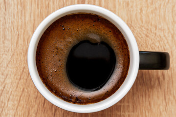 Top view of a ceramic cup of black coffee