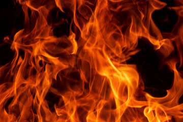 Abstract flame, fire flame texture, background. Blurred moving tongues of fire on a dark background.