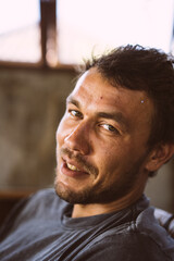 Fototapeta premium Close-up portrait of a young man. The man laughs. A sly smile.