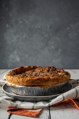 delicious gourmet blueberry nectarine pie on white wood background