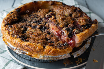 delicious gourmet blueberry nectarine pie on white wood background