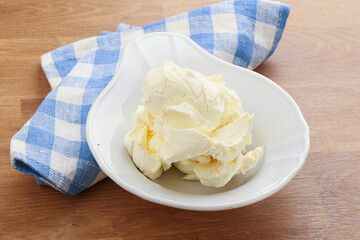 Italian soft mascarpone cheese in the bowl