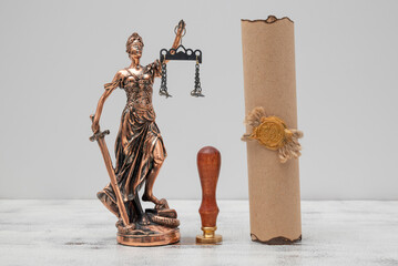 Lady Justice, parchment scroll with seal and stamp on an old wooden table. Law and justice concept
