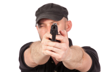 Man pointing gun, isolated on white. Focus on the gun