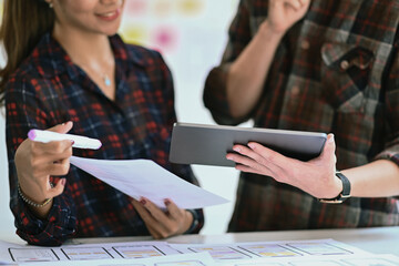 Creative designers brainstorming and planing about mobile application interface wireframe design...