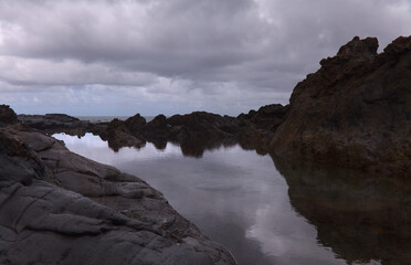 Gran Canaria, north coast, rockpools around Puertillo de Banaderos area protected from the 
ocean waves by volcanic rock barrier
