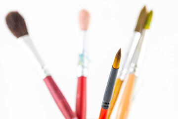 Fototapeta premium Close focus on paintbrushes on white background.
