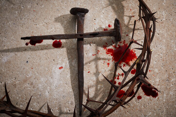 Easter concept. Crown of thorns with Nails and blood drops on a stone background.