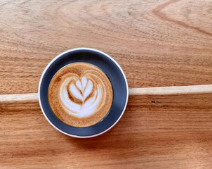 top view of cup of coffee on wooden table
